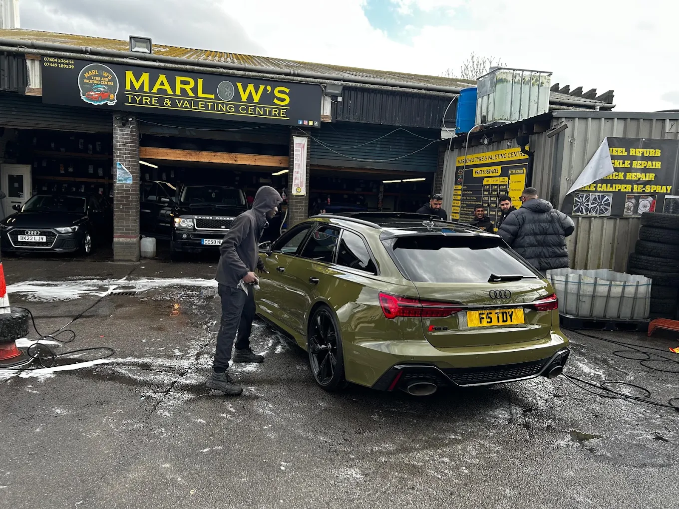 Car being washed with foam at Marlow's Street Car Wash